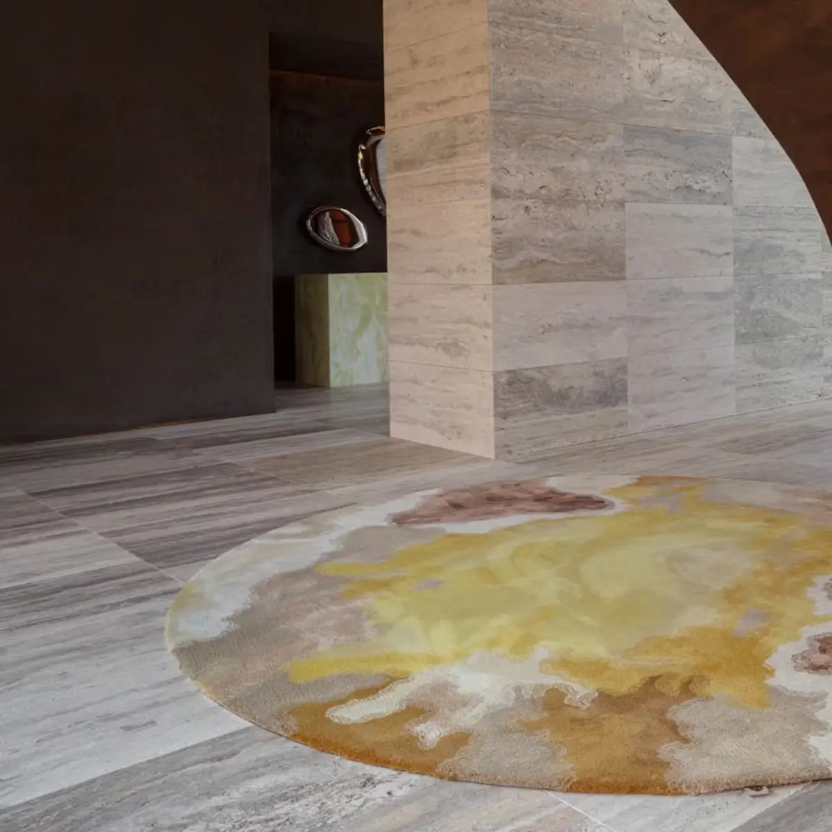 Modern interior with patterned rug and stone walls