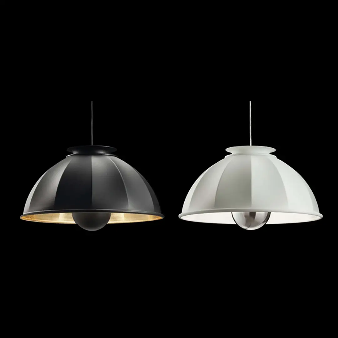 Two pendant lamps, one black, one white, against black