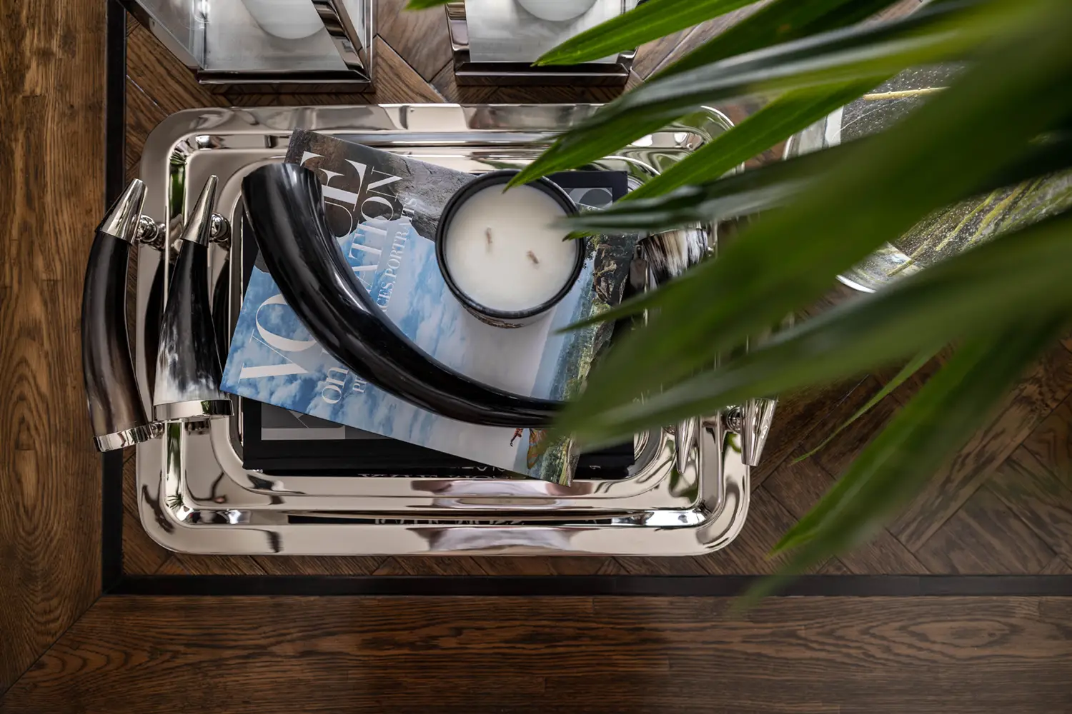 Artistic chrome faucet over stylish magazine stack