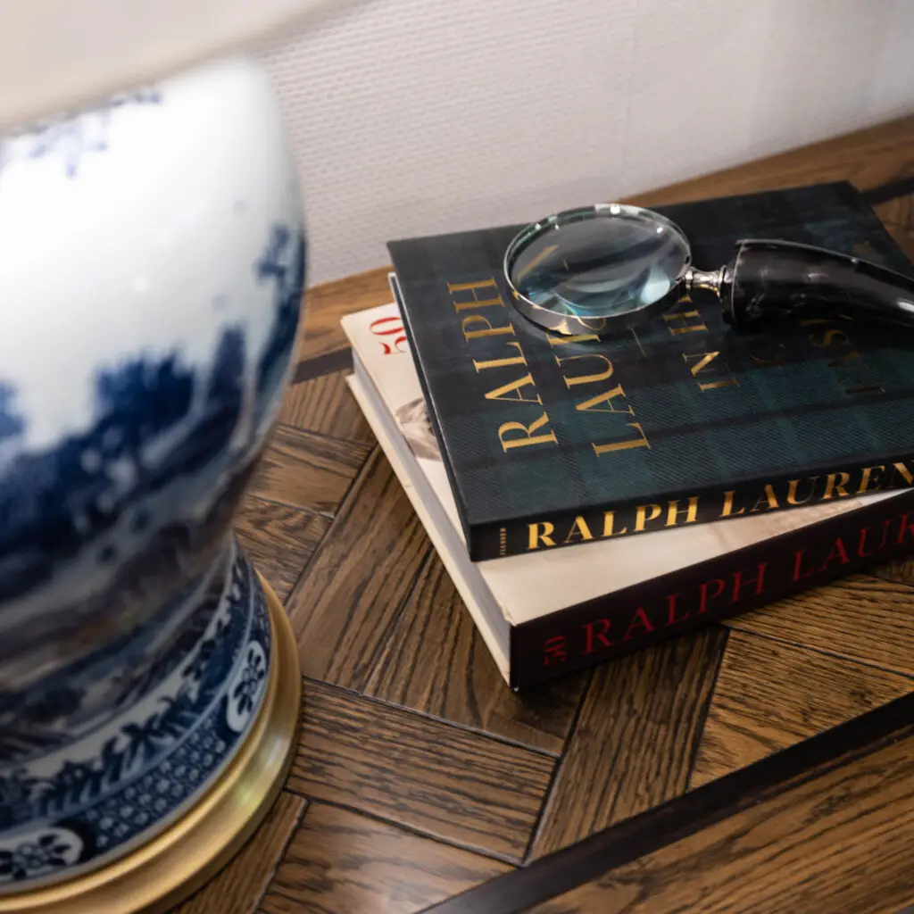 Books and magnifying glass on wooden floor