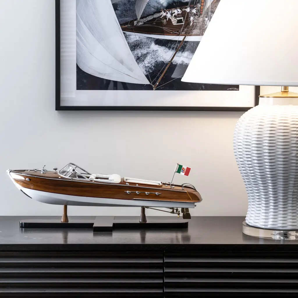 Model boat with Italian flag on office desk