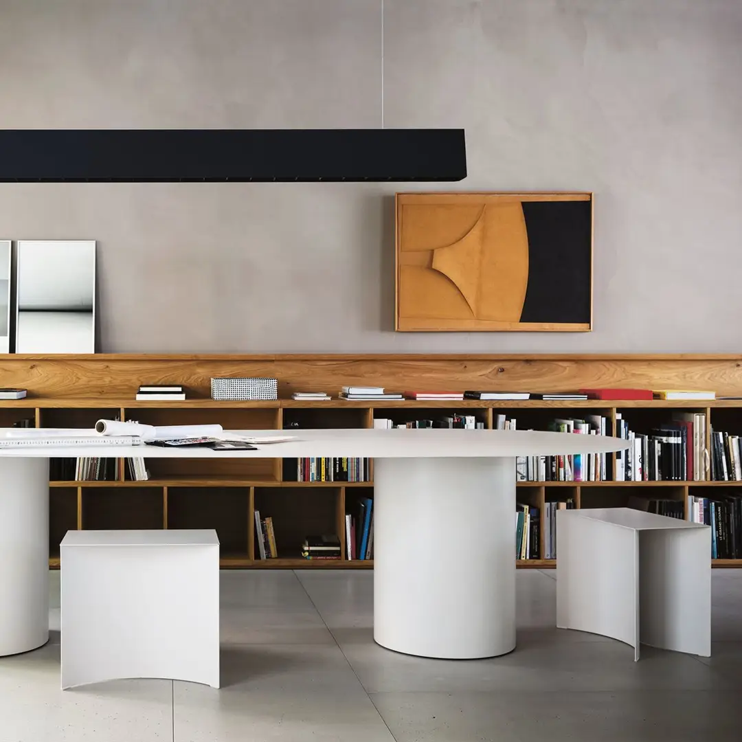 Modern minimalist home office with books and abstract art
