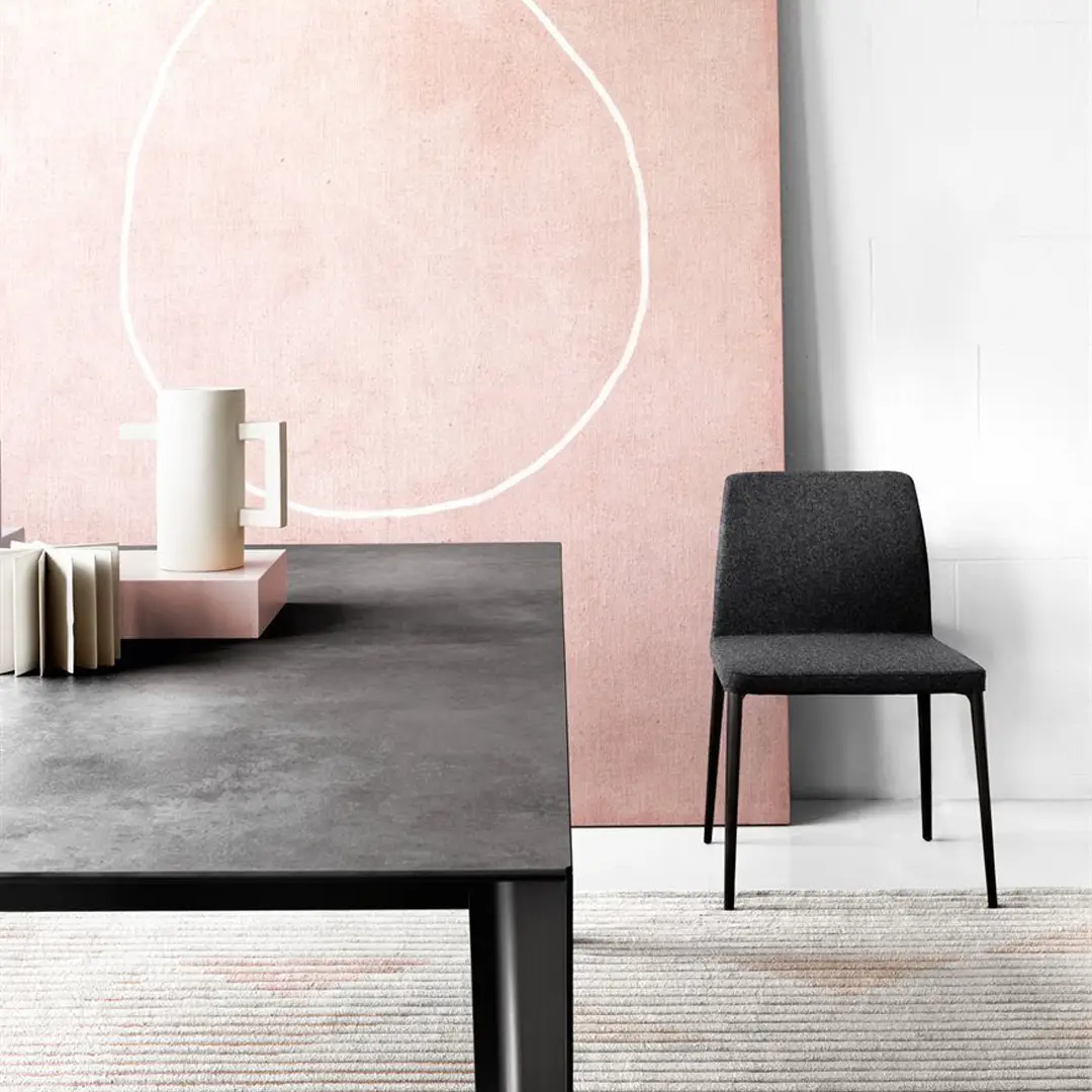 Minimalist interior with table, chair, and decorative wall