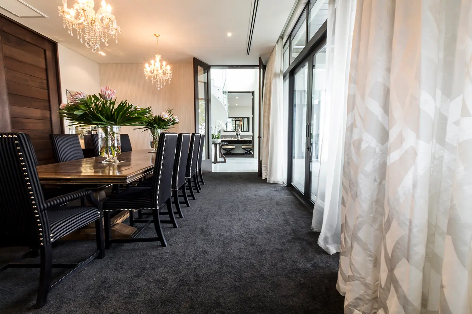 Elegant dining room with chandelier and balcony access