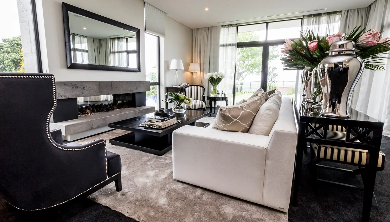 Elegant living room with modern furniture and large windows