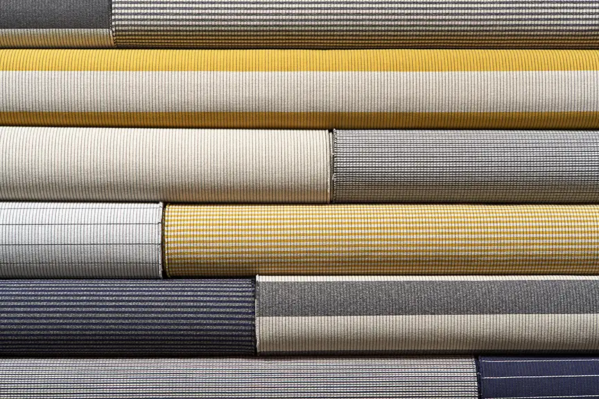 Stack of various colored fabric rolls