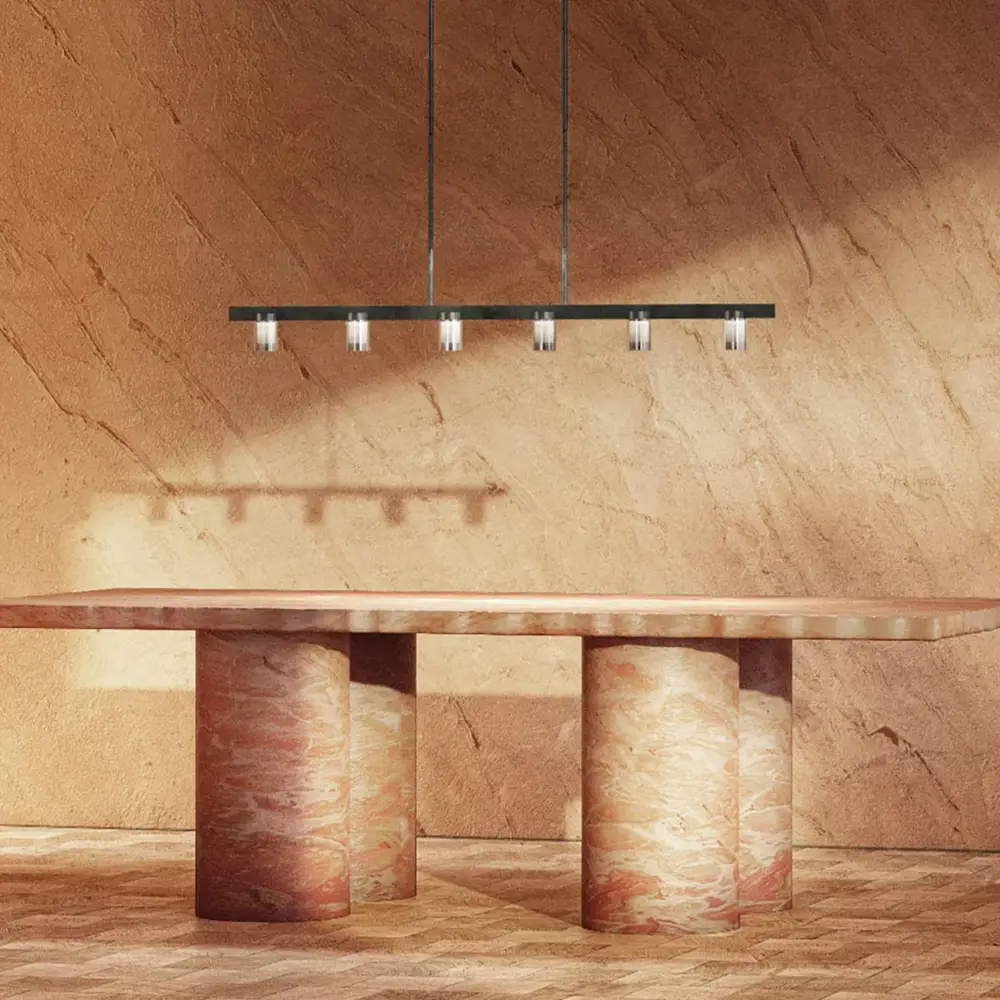 Modern table under linear pendant lights, textured backdrop