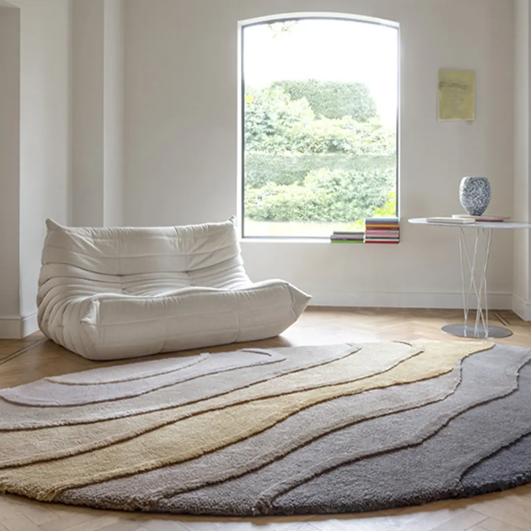 Modern cozy nook with plush chair and textured rug