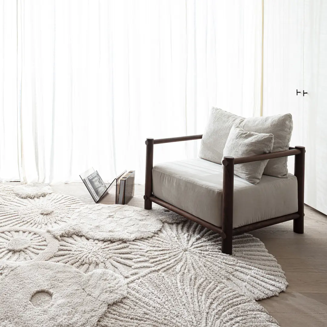 Modern minimalist chair near window with textured rug