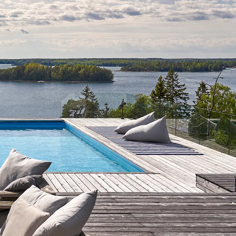 Lakeside pool with deck and scenic forest view