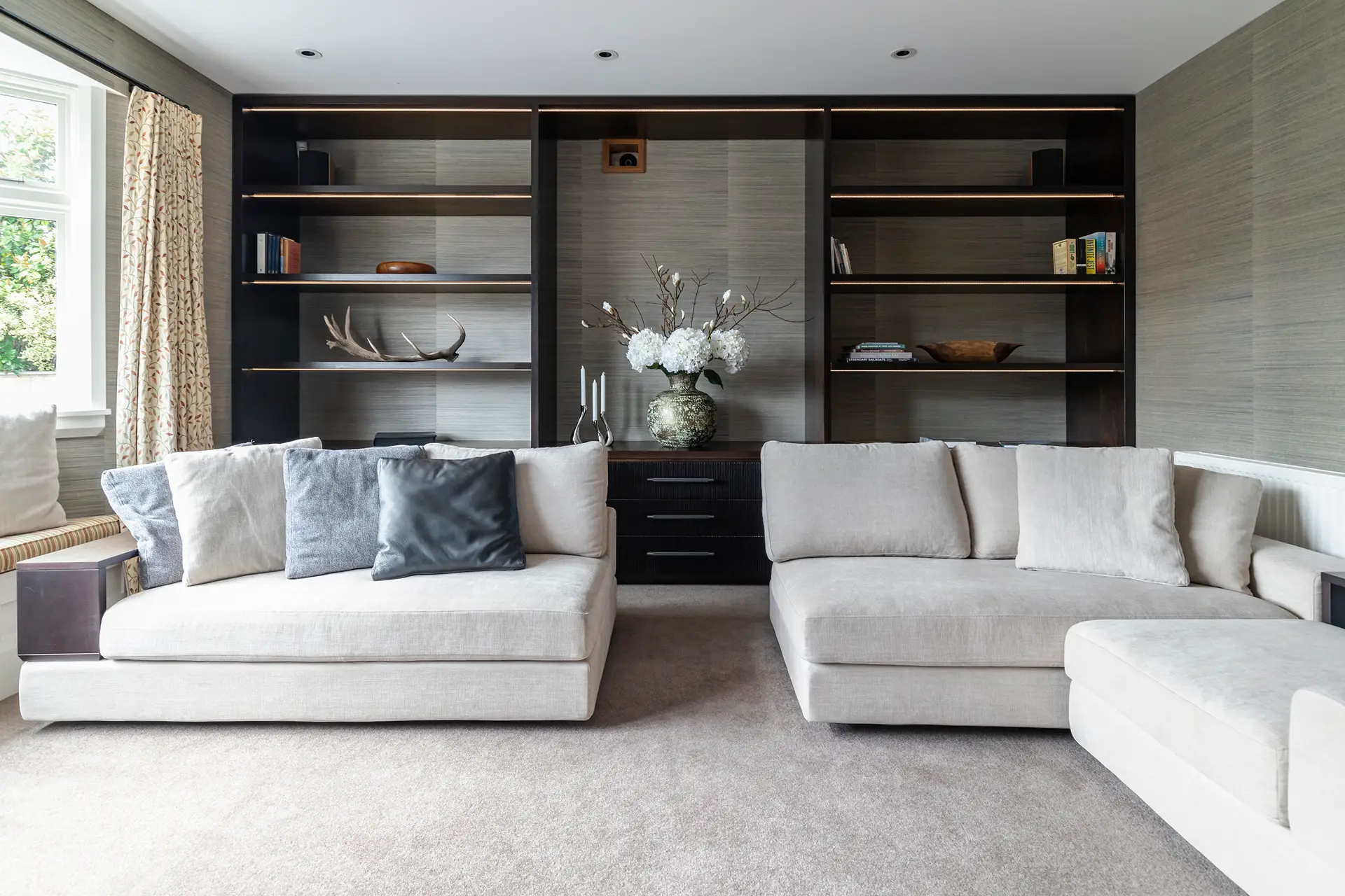 Elegant living room with modern sofas and built-in shelves