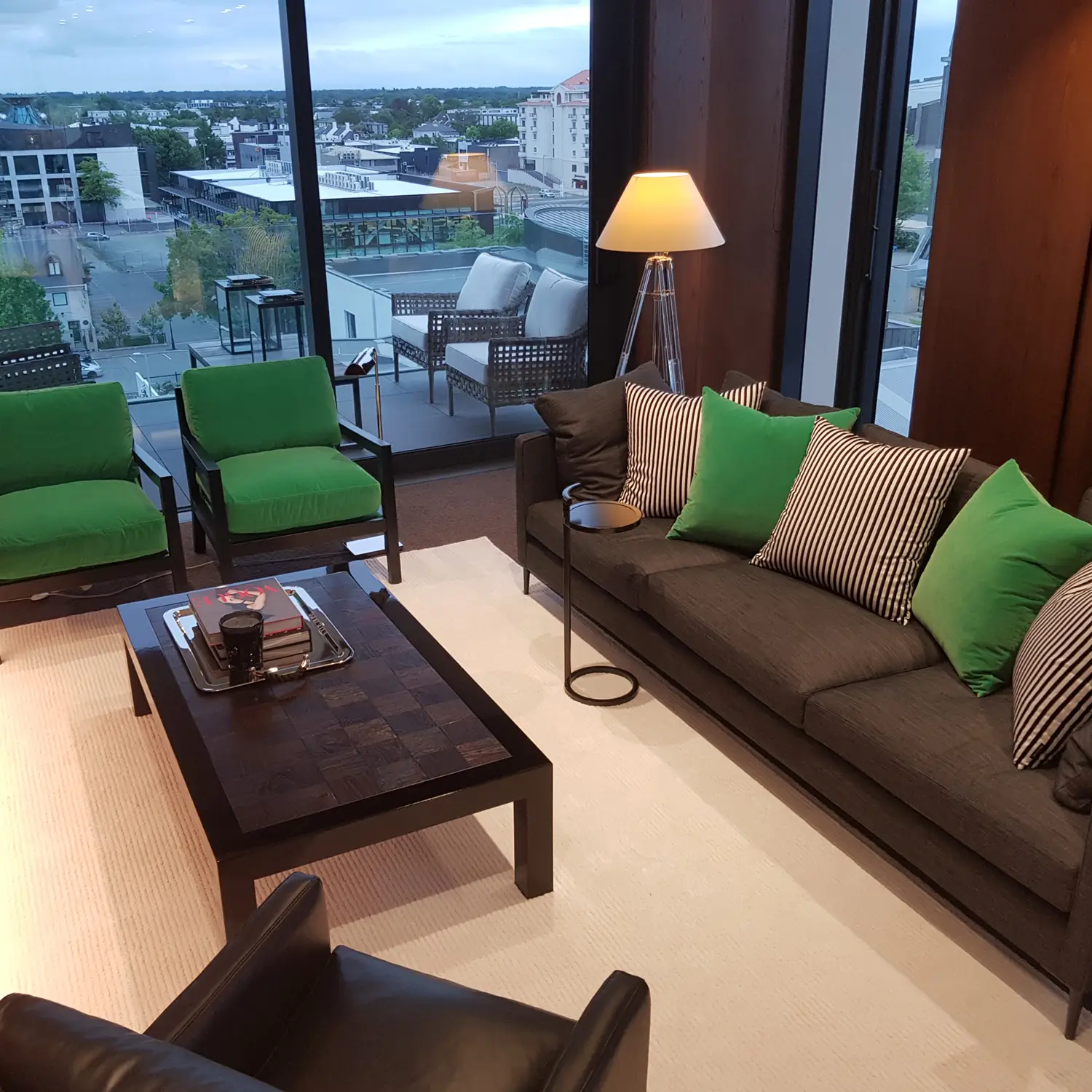 Modern living room with balcony view at dusk