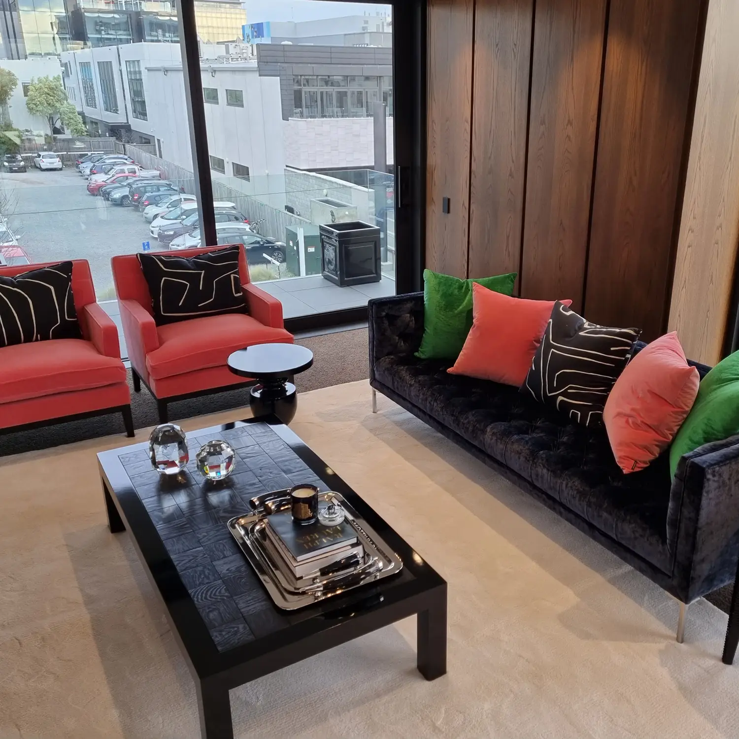 Modern living room with colorful sofas and urban view