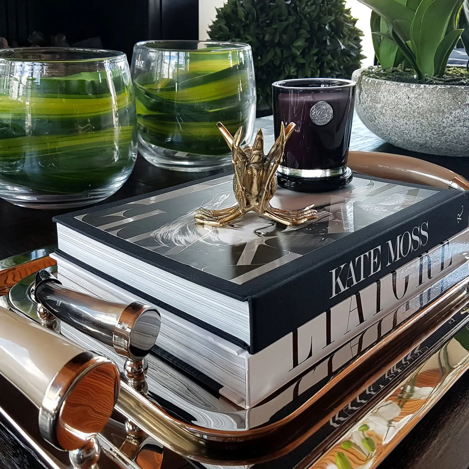 Elegant home decor with books, candles, and decorative bowls
