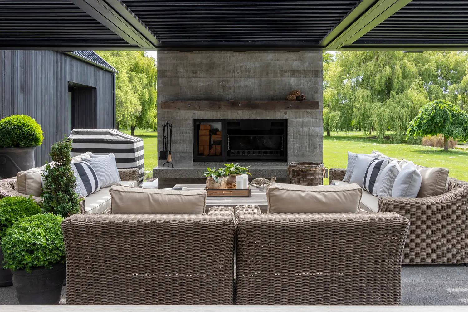 Elegant outdoor patio with fireplace and comfortable seating.