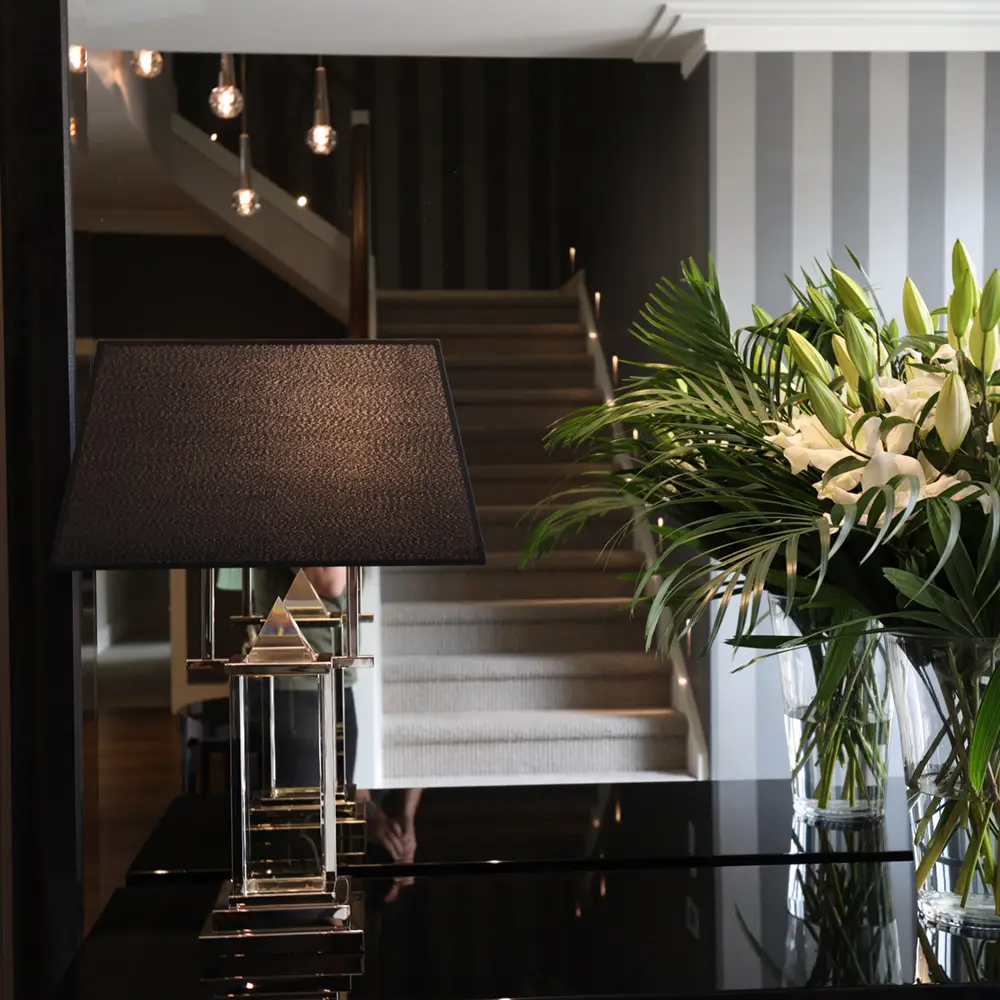 Elegant interior with lamp, stairs, and plant decorations