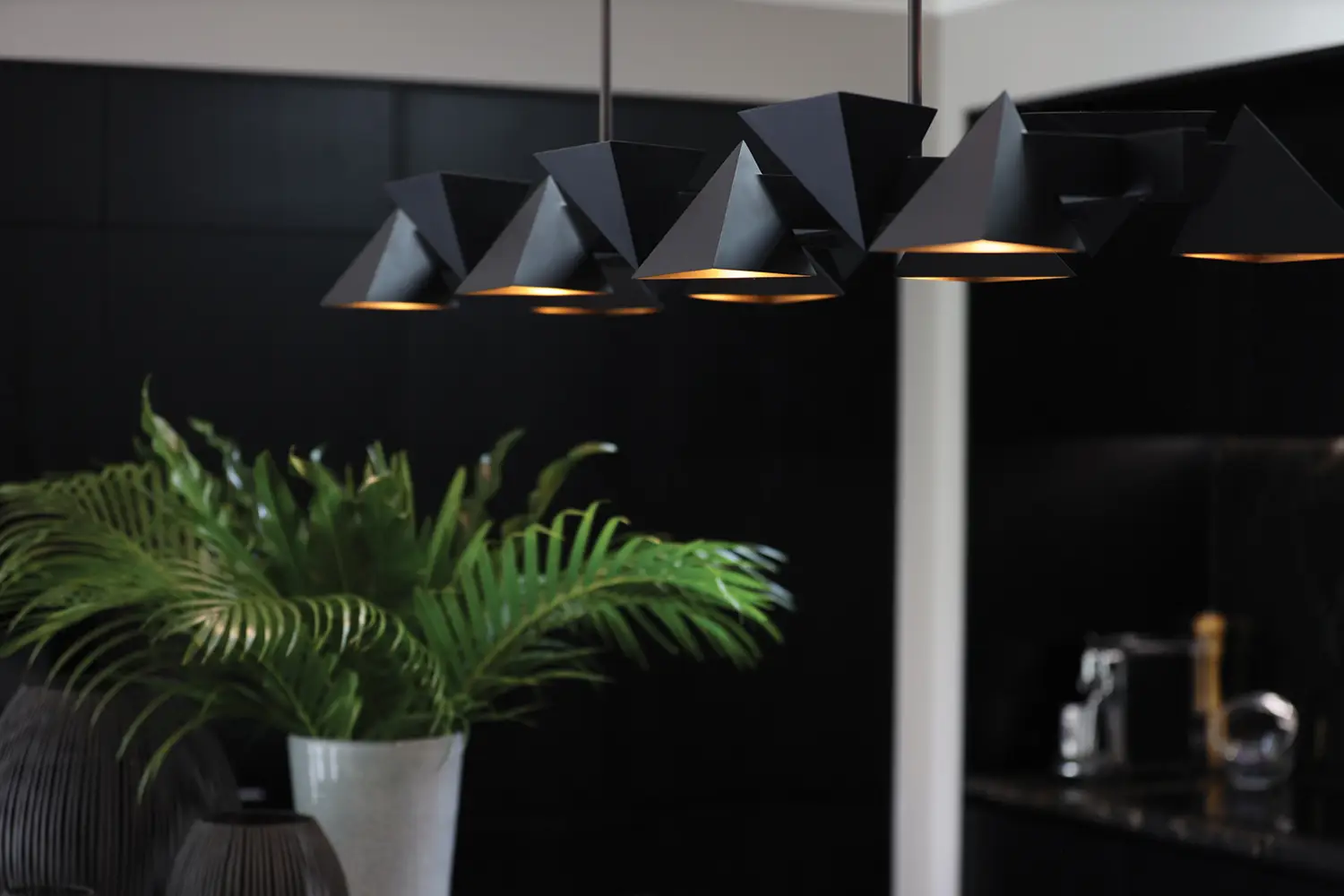 Modern black pendant lights above kitchen counter