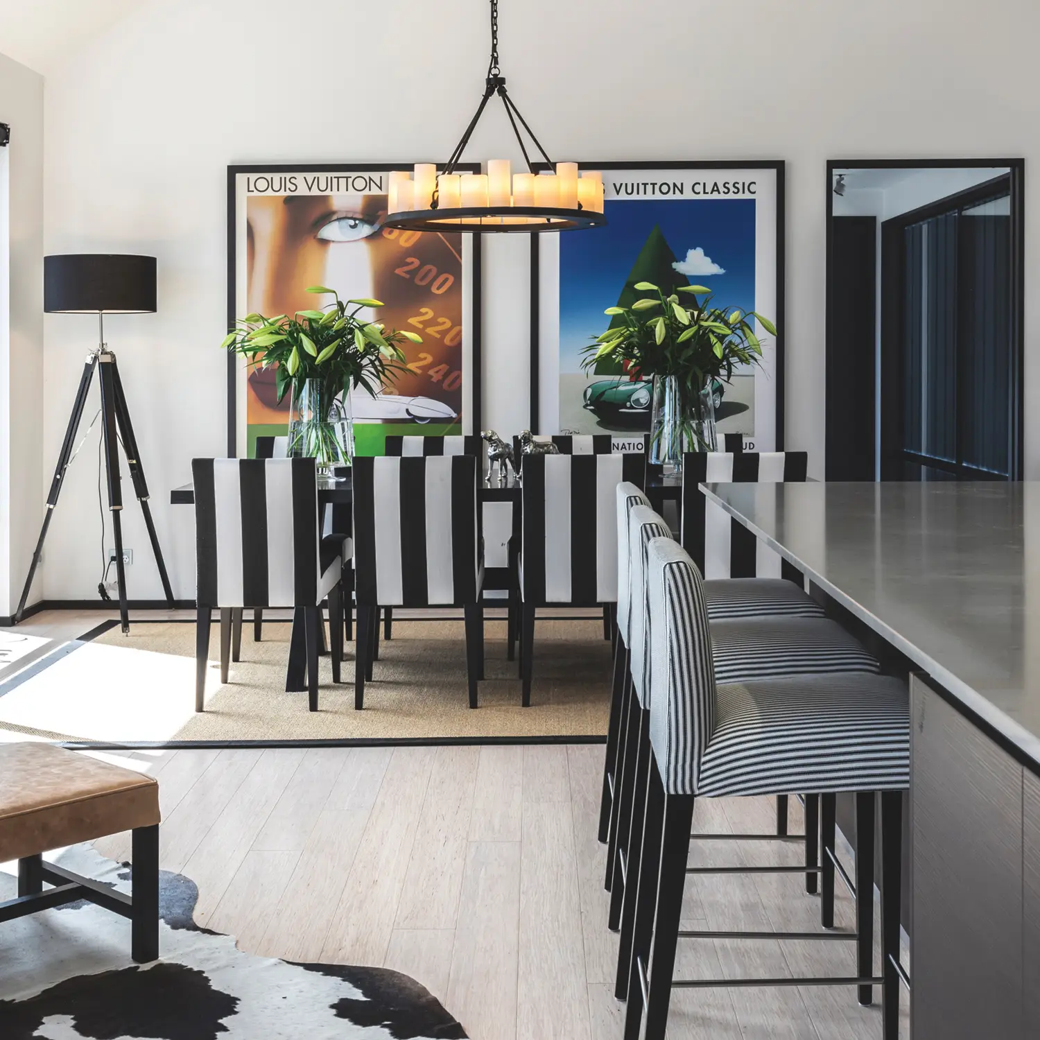 Modern dining room with striped chairs and large posters
