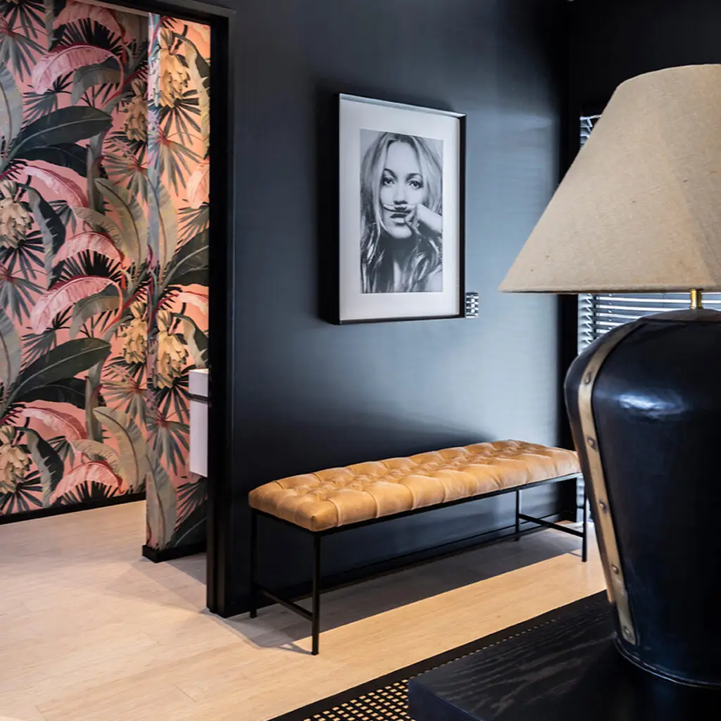 Elegant interior with tropical wallpaper and framed portrait