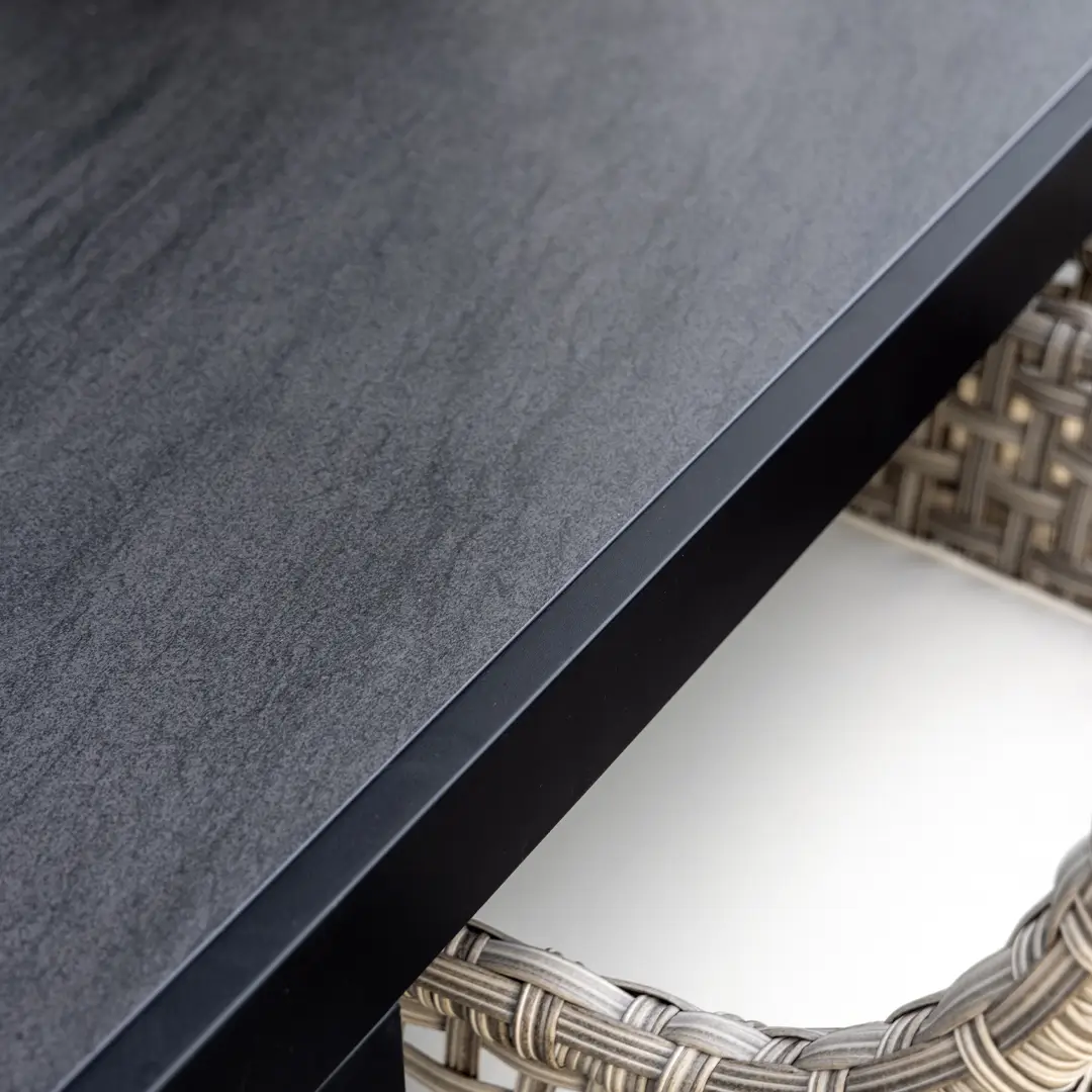 Romano-dining_table_1 Close-up of black textured tabletop with wicker detail