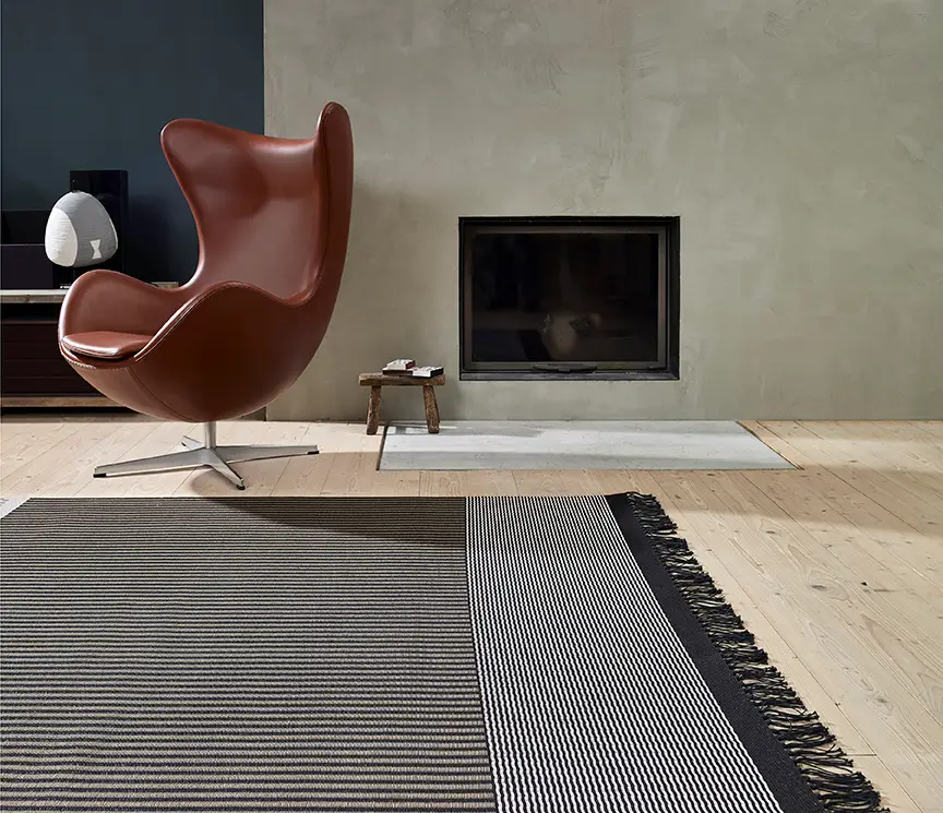 Modern interior with stylish leather chair and fireplace