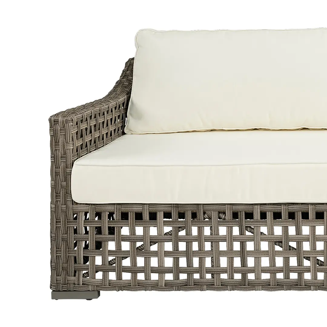 Woven outdoor sofa with white cushions