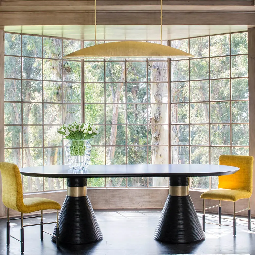 Modern dining room with large window and forest view