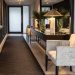 Elegant indoor hallway with decorative chairs and plants