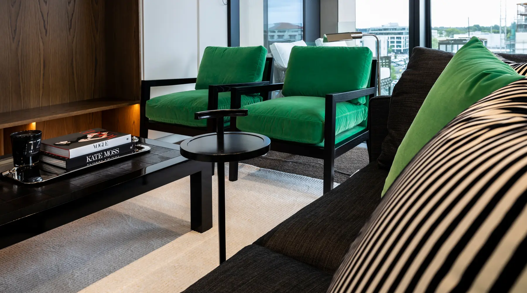 Modern living room with green armchairs and chic decor