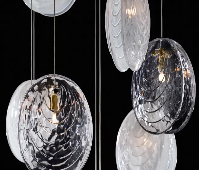 Elegant suspended glass pendant lights in dark background