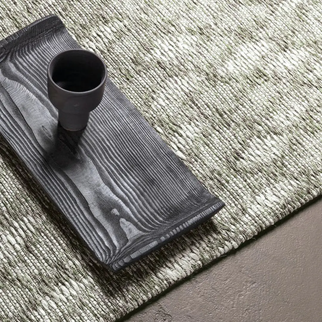 Black vase on textured gray wooden board