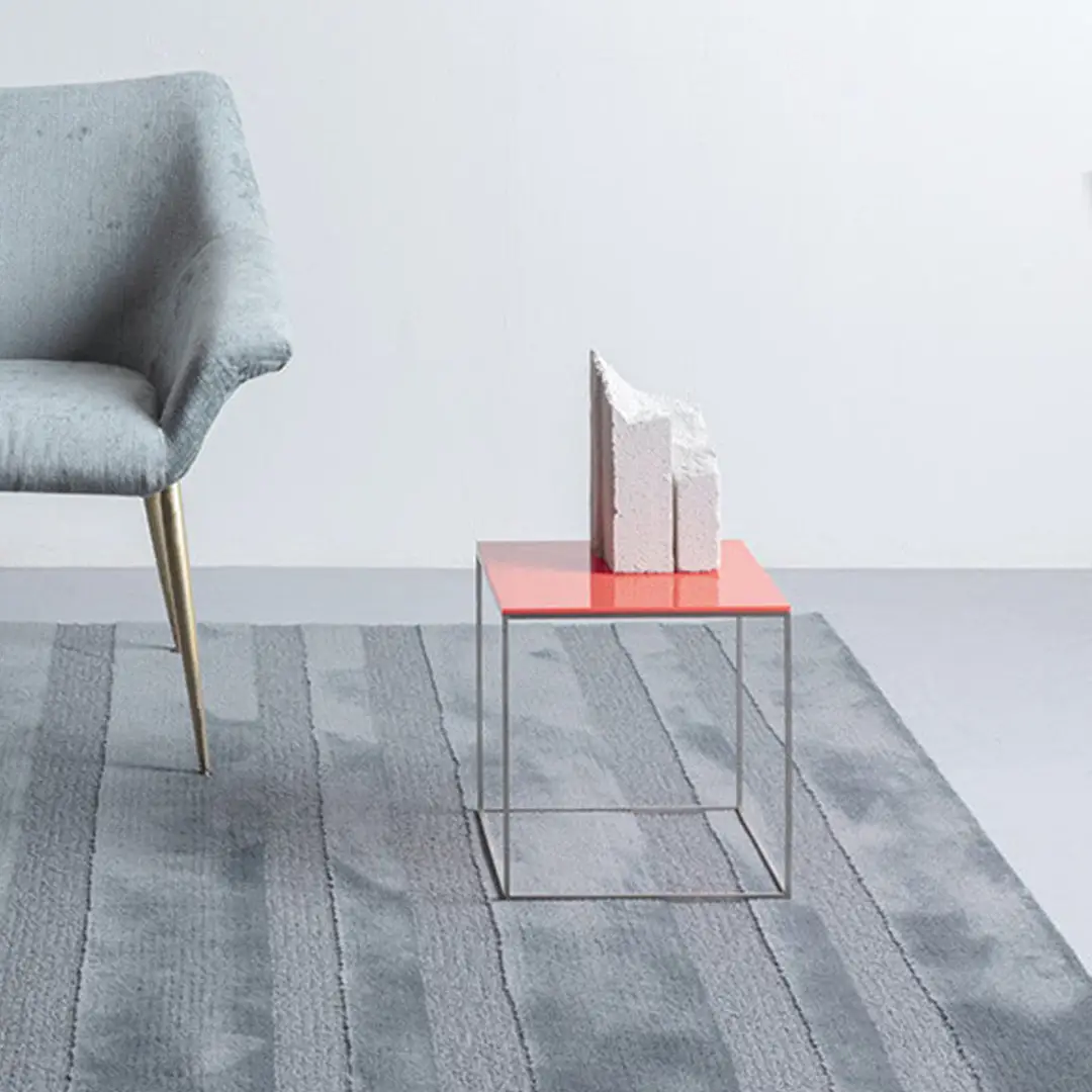 Modern chair and abstract sculpture on red table