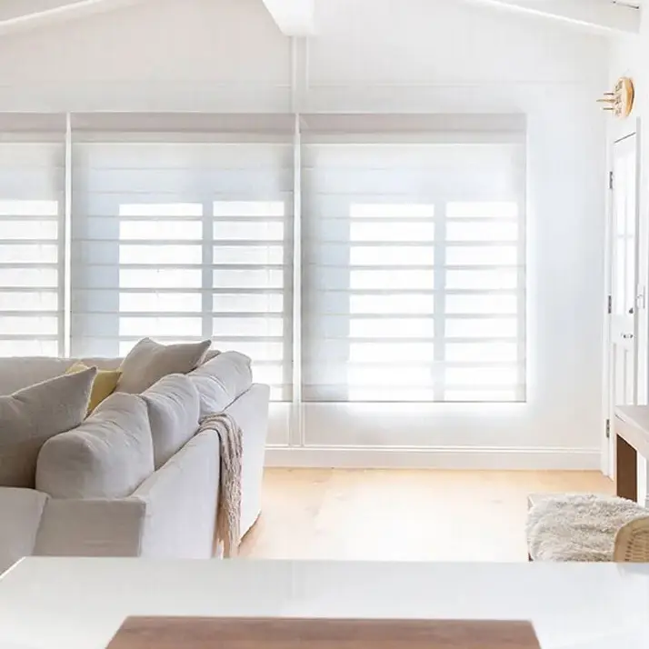 Bright modern living room with large windows and sofa