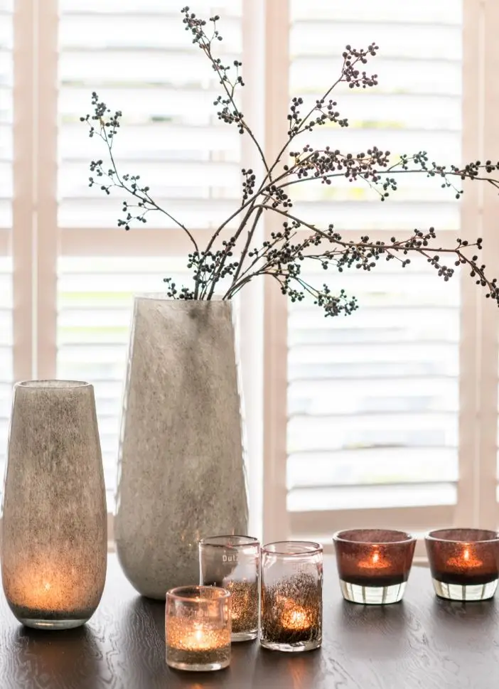 Elegant centerpiece with candles and decorative vase