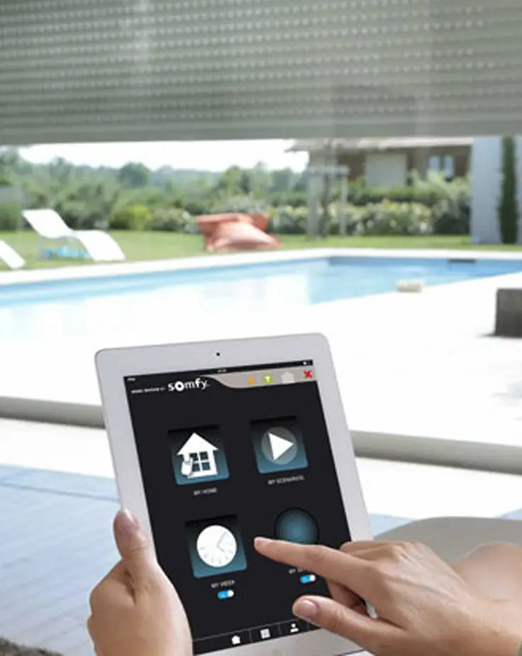 Person using tablet to control home automation