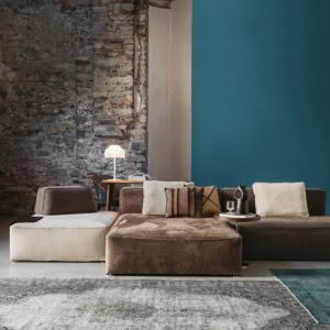 Modern living room with exposed brick and blue wall