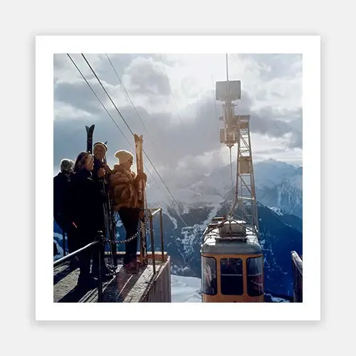 Tourists waving at mountain cable car station