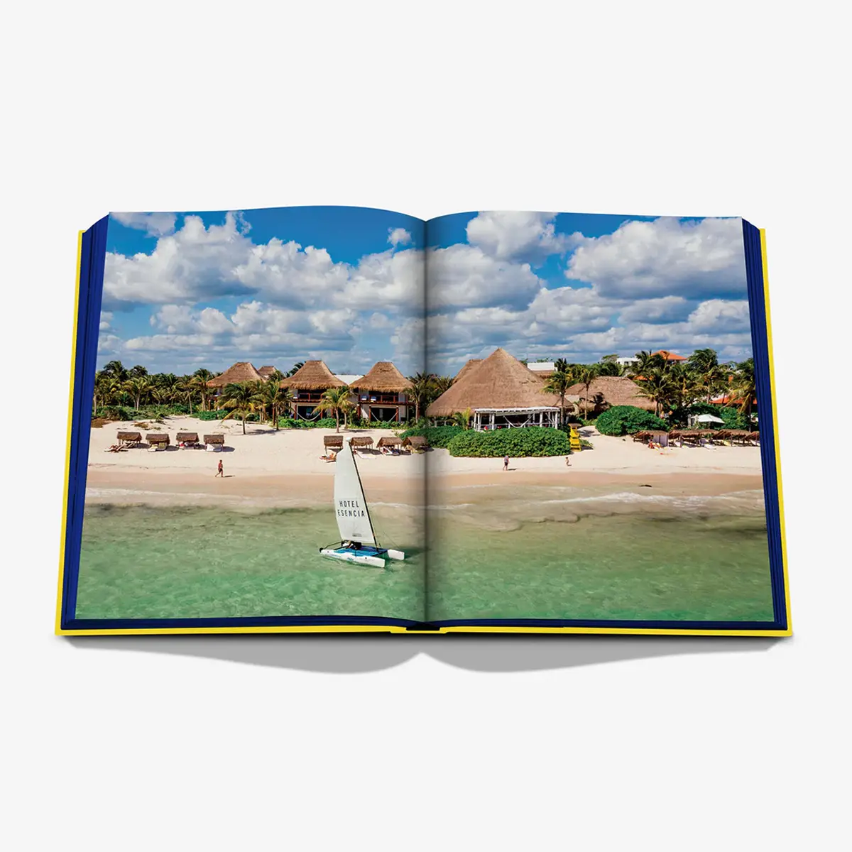 Open travel book showcasing tropical beach resort