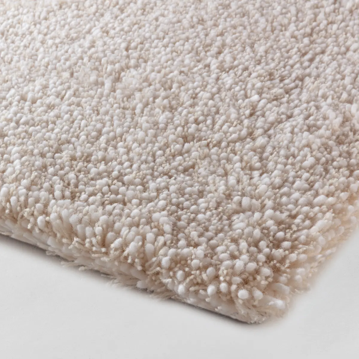 Close-up of textured white shag carpet