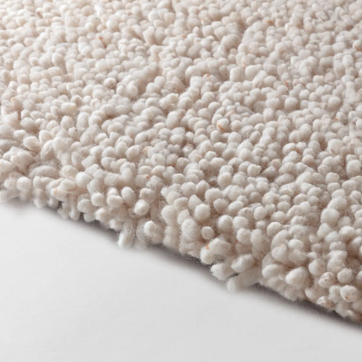 Close-up of textured white shag carpet