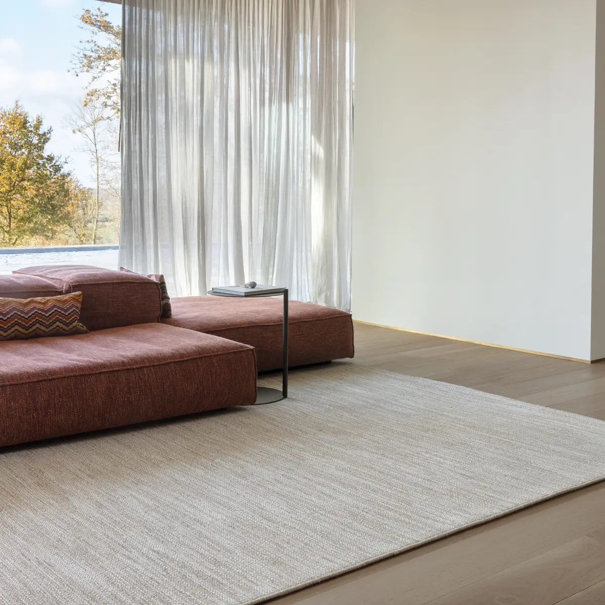 Modern room with large window and brown couch