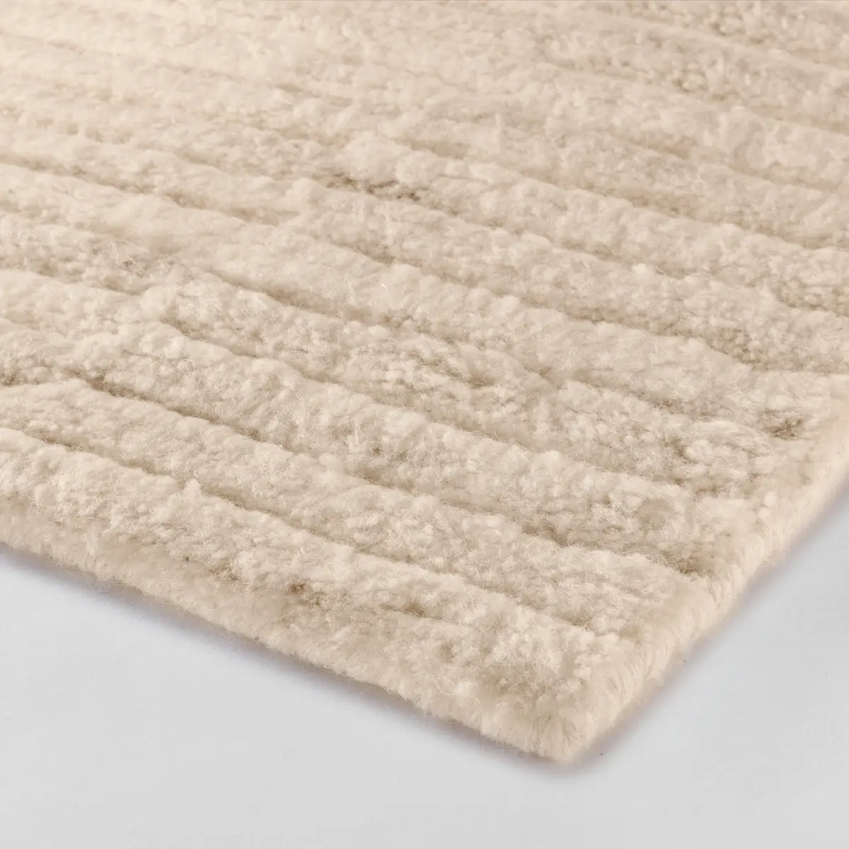Close-up of textured beige shag rug