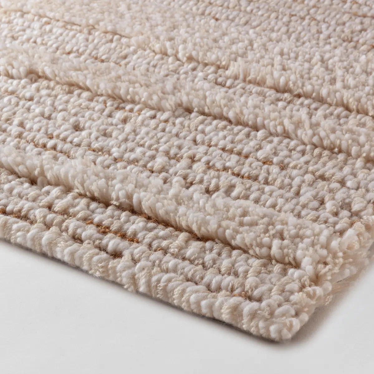 Close-up of textured white braided rug