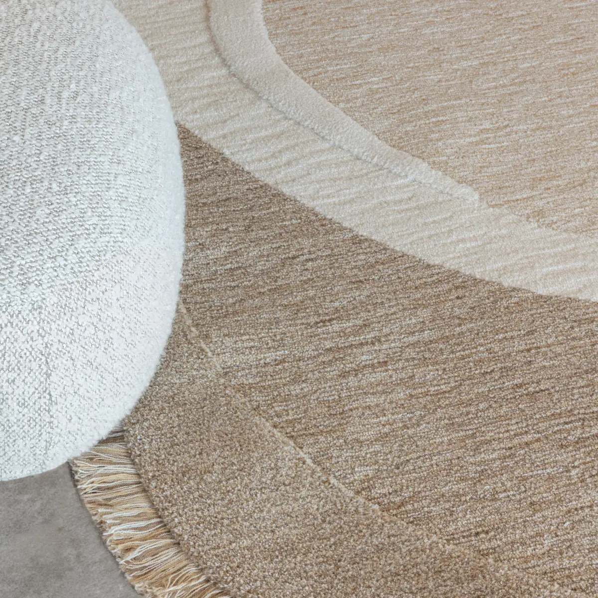 Zumba_Octavo_Creamy_Taupe_2 Close-up of textured beige circular area rug