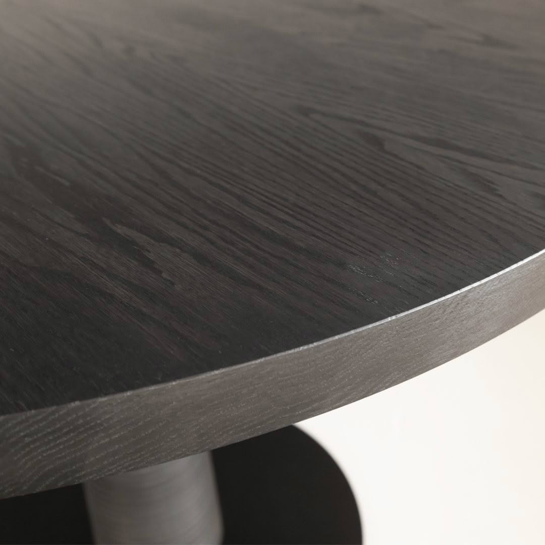 Close-up of dark wooden round table surface