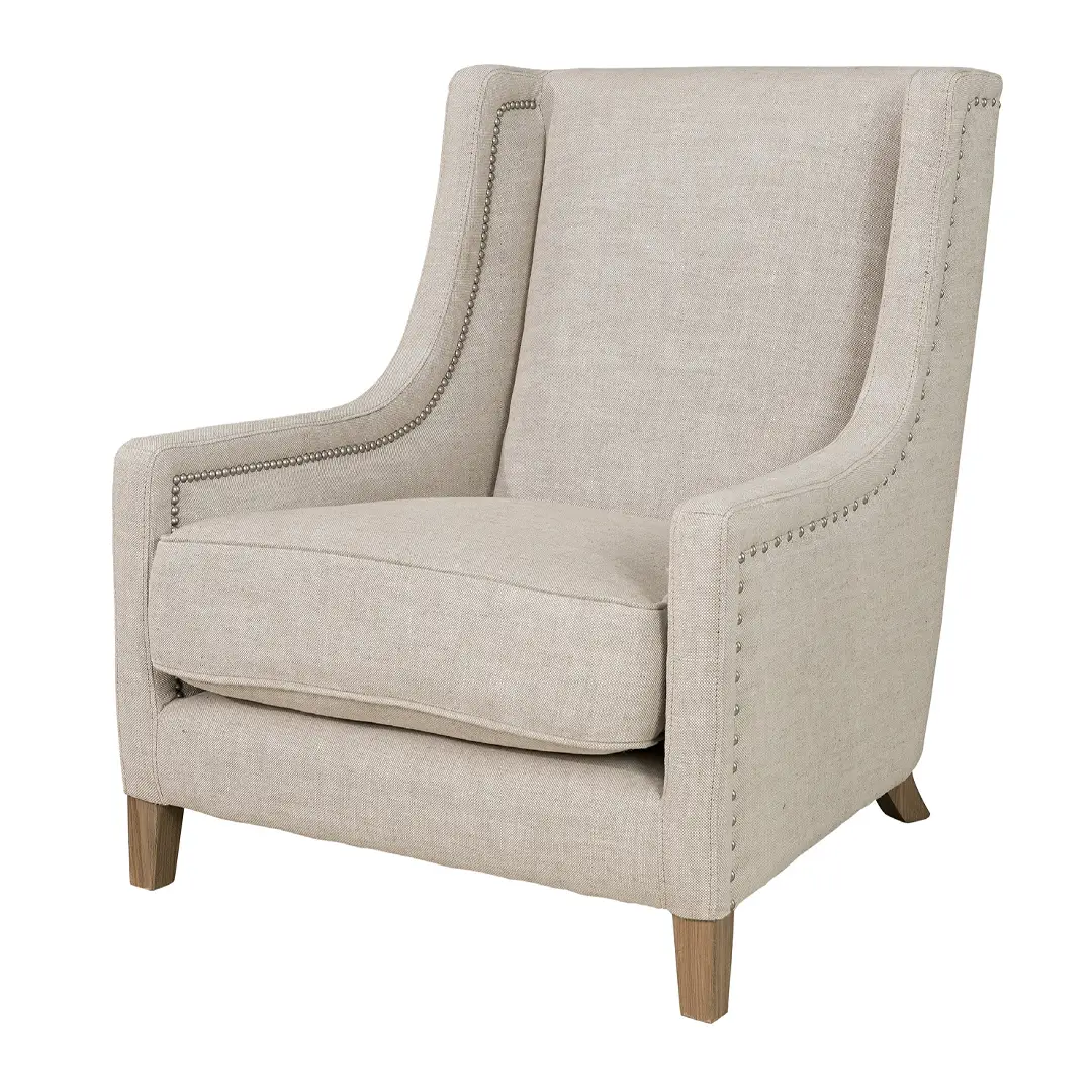 Beige upholstered armchair with nailhead trim