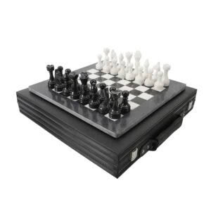 Black and white chess set on marble board