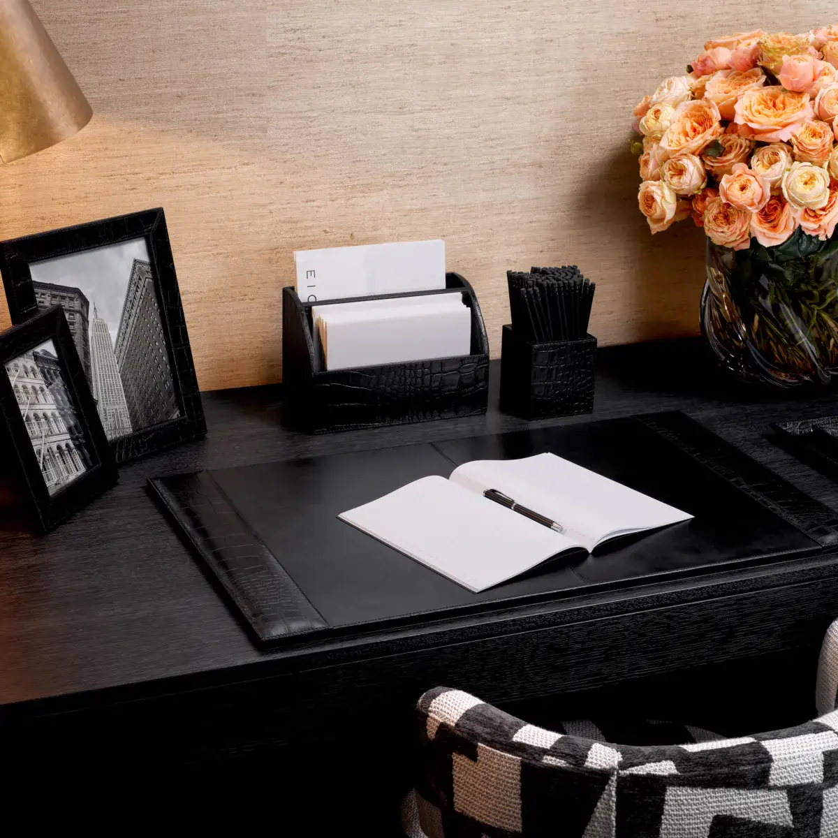 Elegant desk setup with accessories and flowers