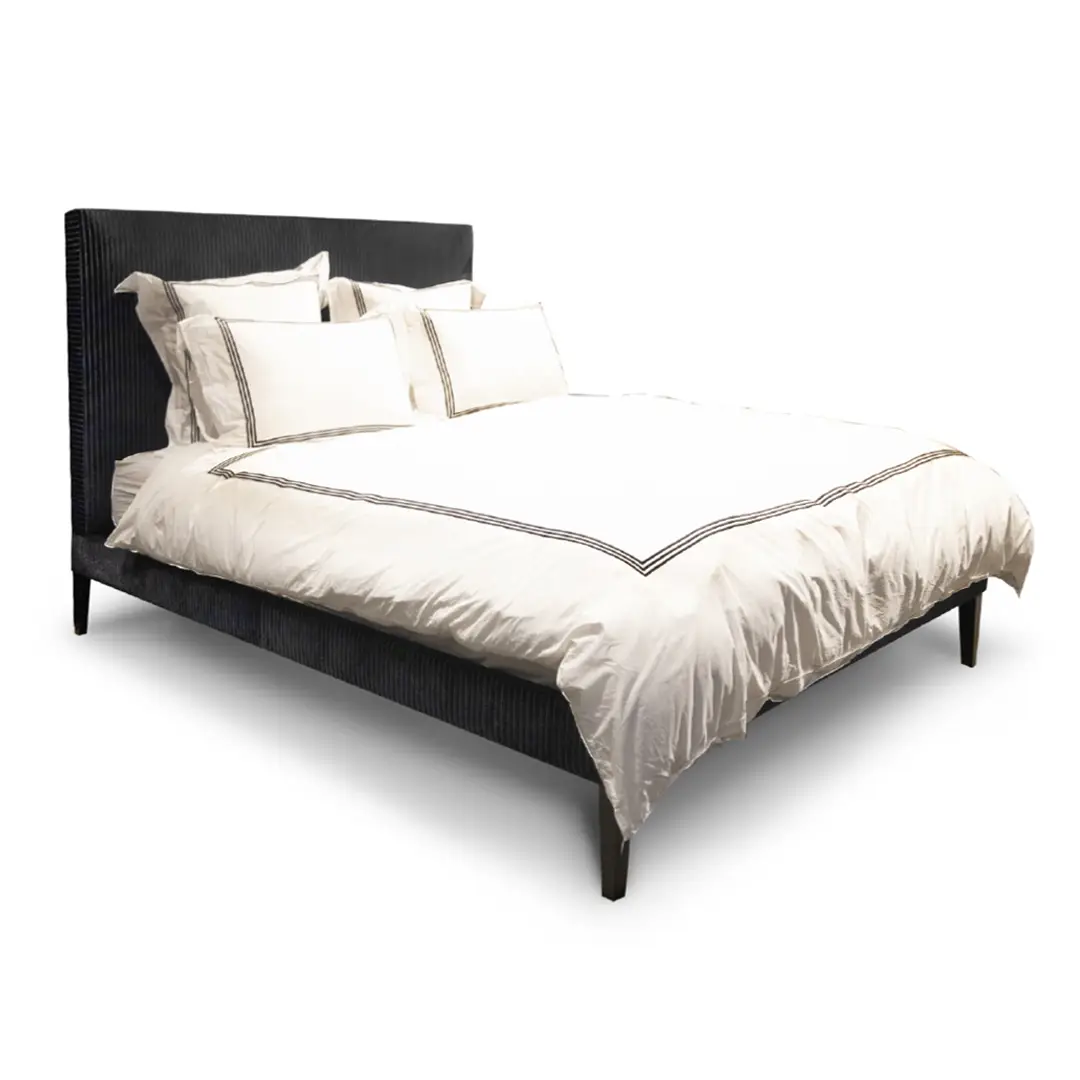 Dark blue bed with white bedding isolated on white