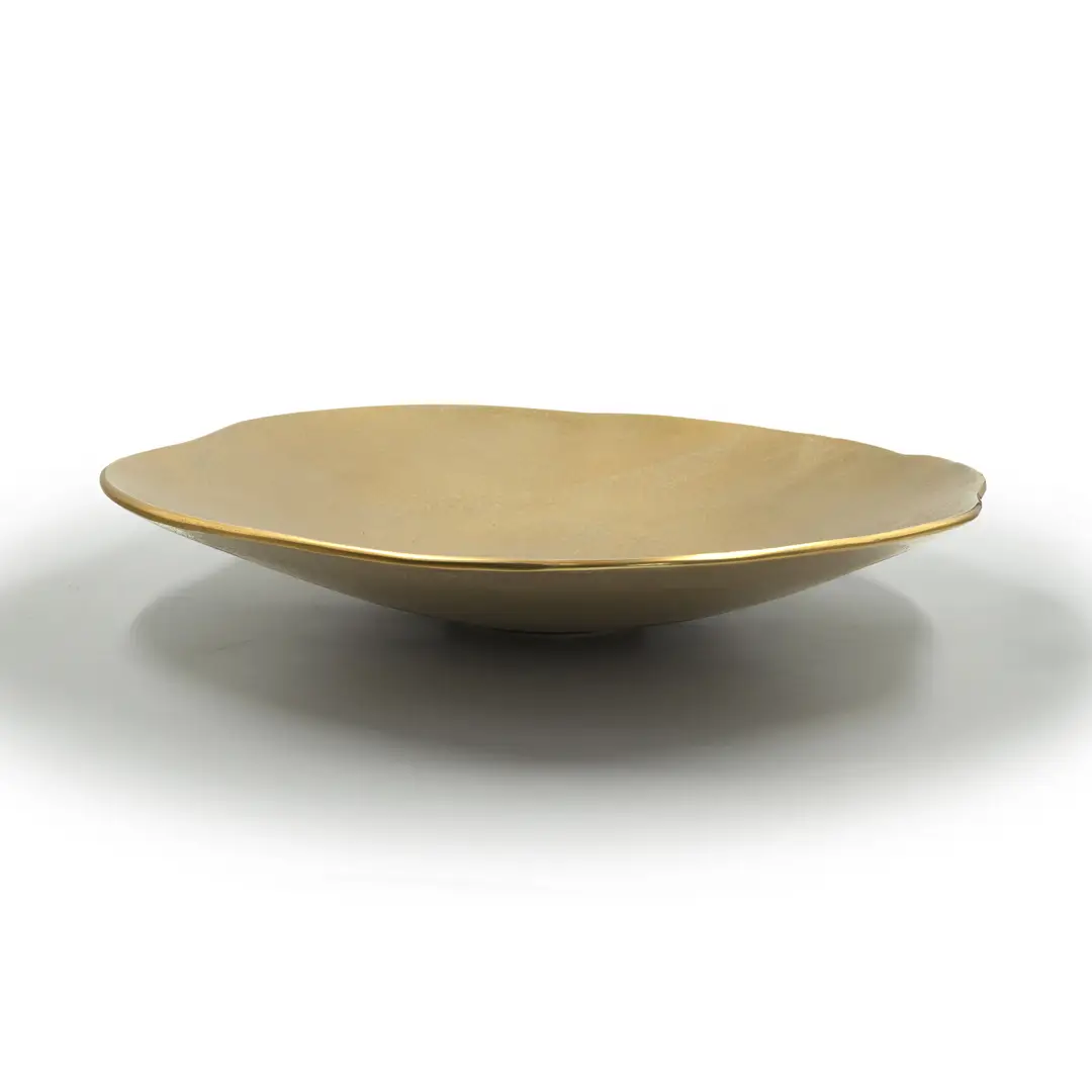 Minimalist gold ceramic plate on white background